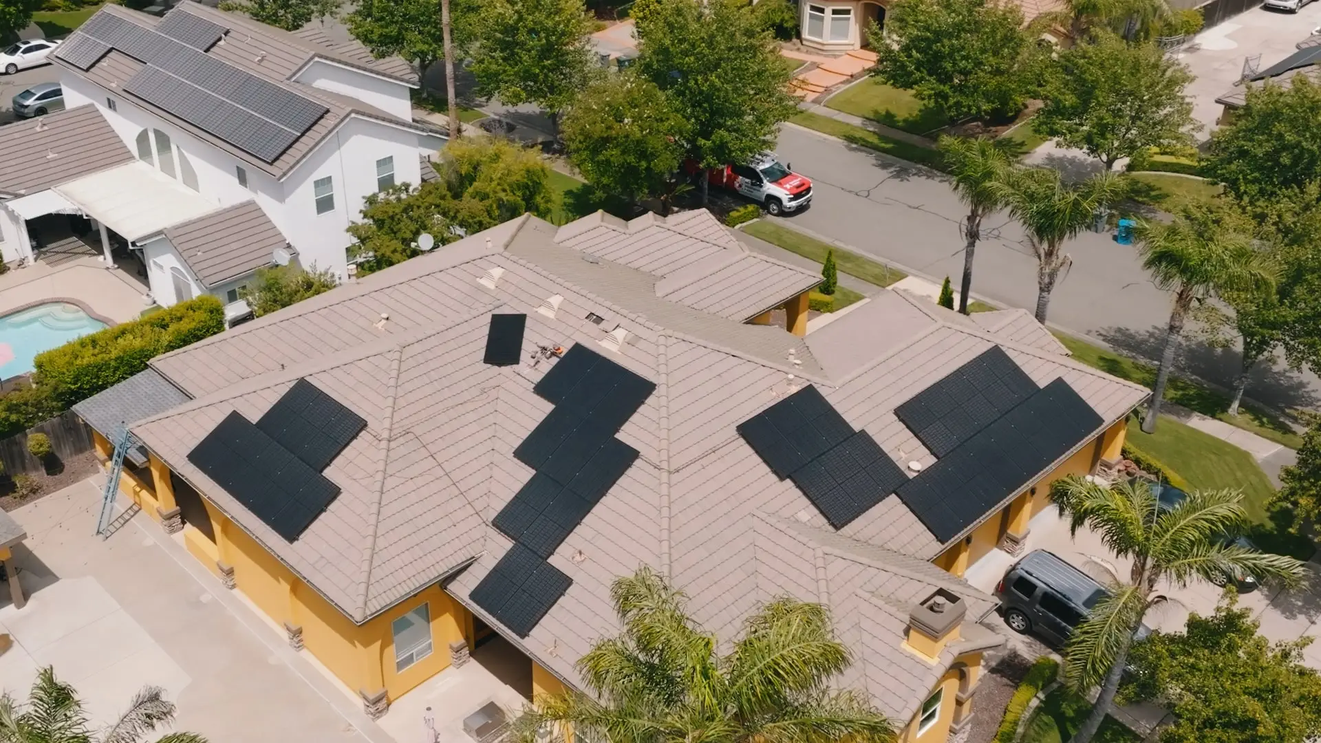 Aerial view of a Nor-Cal home, its roof covered in Westhaven solar arrays, with a Westhaven truck parked on the street below.